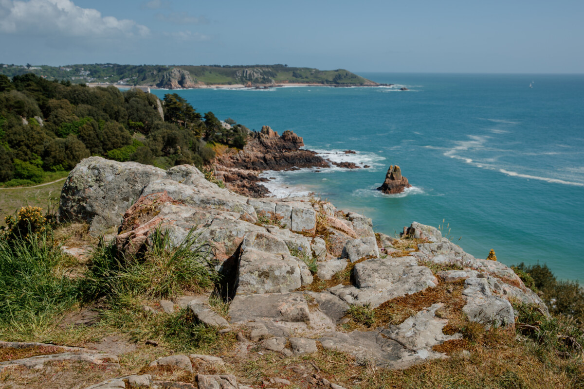 Rocky coastline overlooking Beauport Bay and blue sea