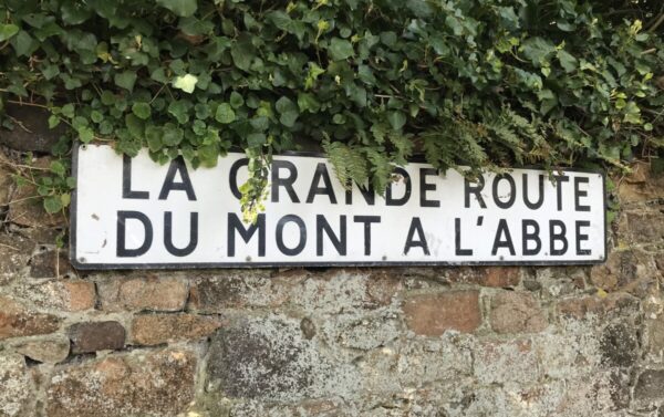 Mont-à-l’abbé road sign on a stone wall